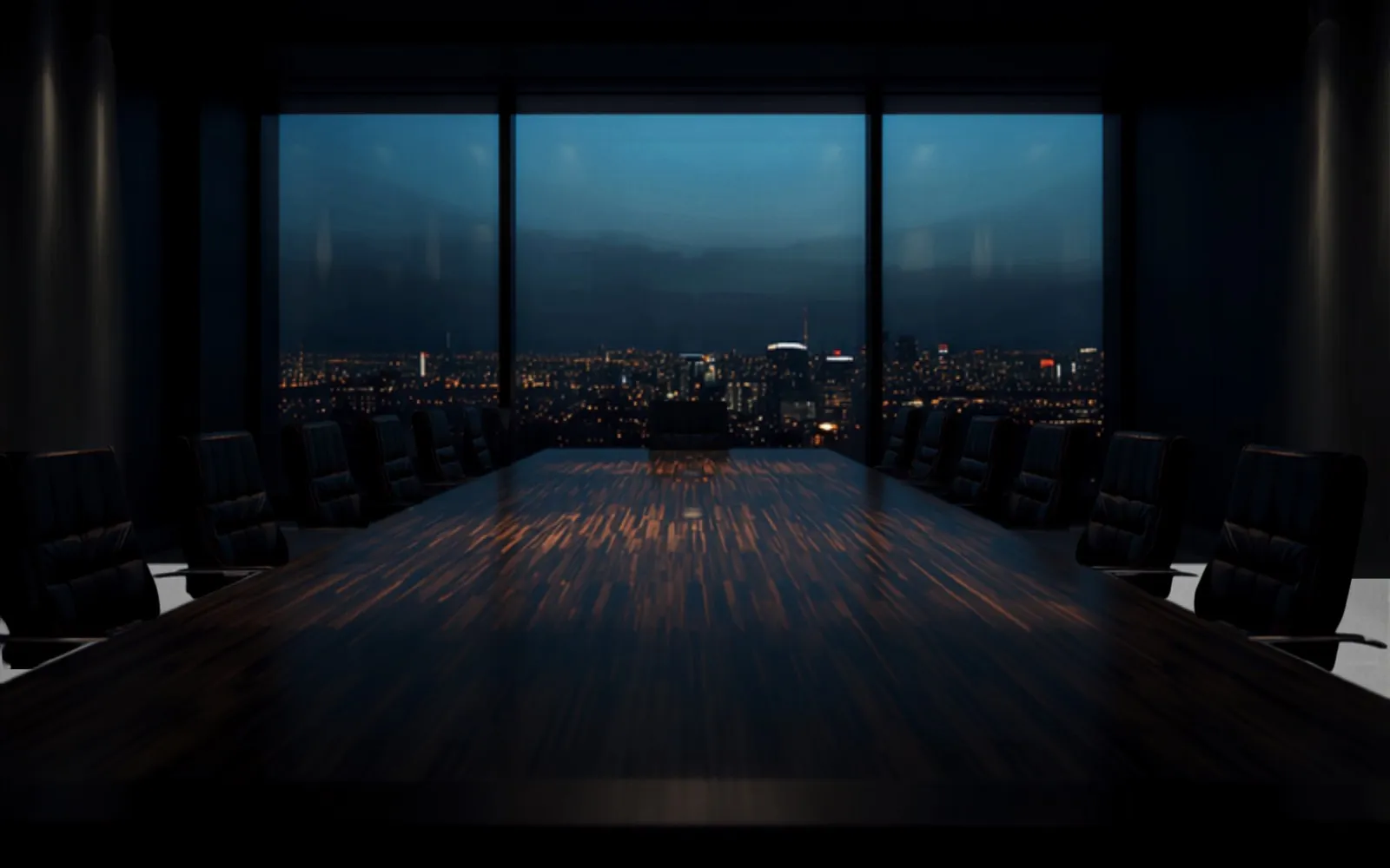 Executive boardroom overlooking a city skyline at dusk